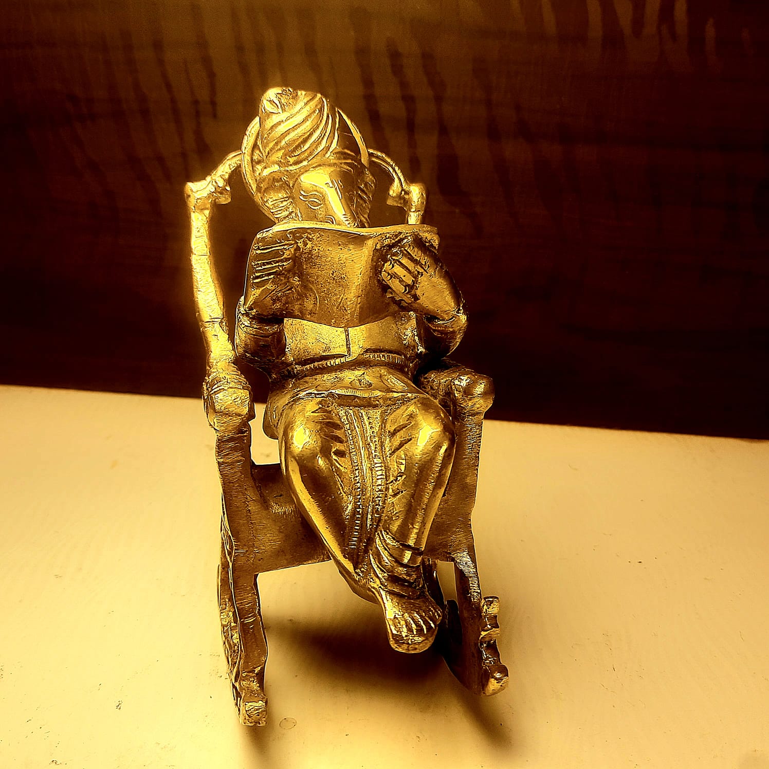 Divine Brass Ganesh Reading in Chair Figurine