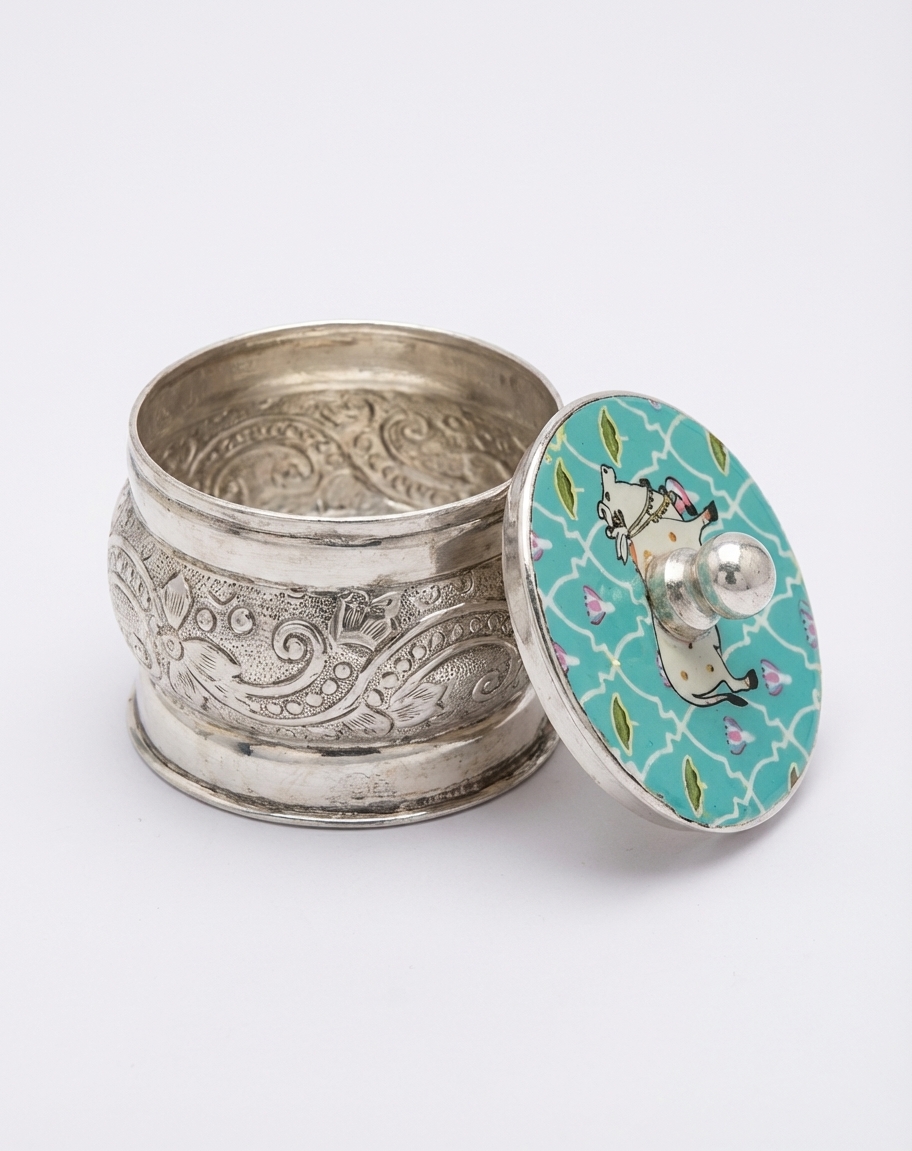 enchanting german silver kumkum box with meenakari cow motif