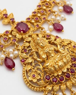exquisite gold toned temple maang tikka with ruby accents