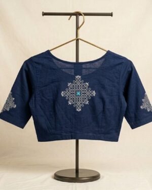 Navy blue stretch banian material saree blouse featuring a traditional white geometric kolam printed design on the back and sleeves, displayed on a clothing stand