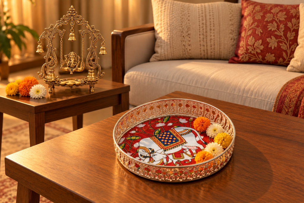 German silver cow motif tray and brass Ganesha swing figurine styled in a living room.